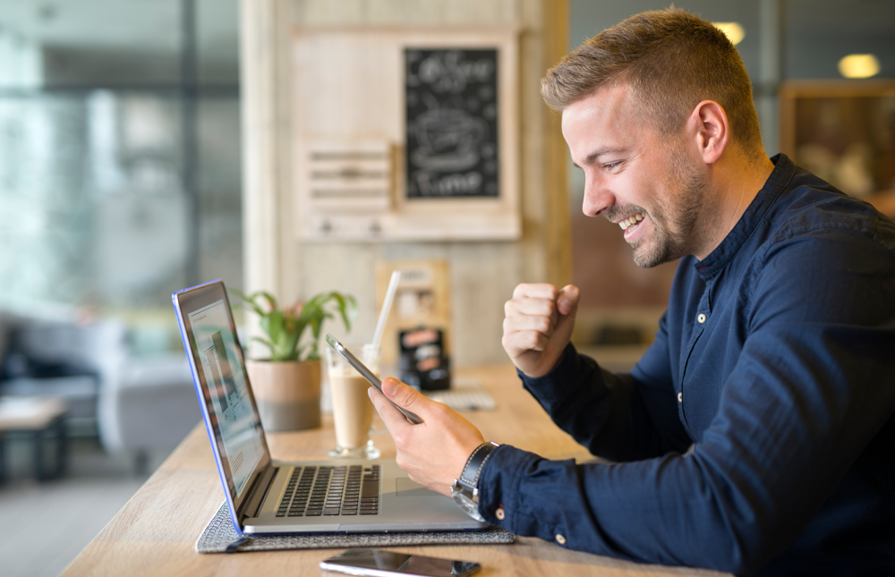 turbotax discounts are available for america's credit union members man fist pump excited after using discount on his cell phone