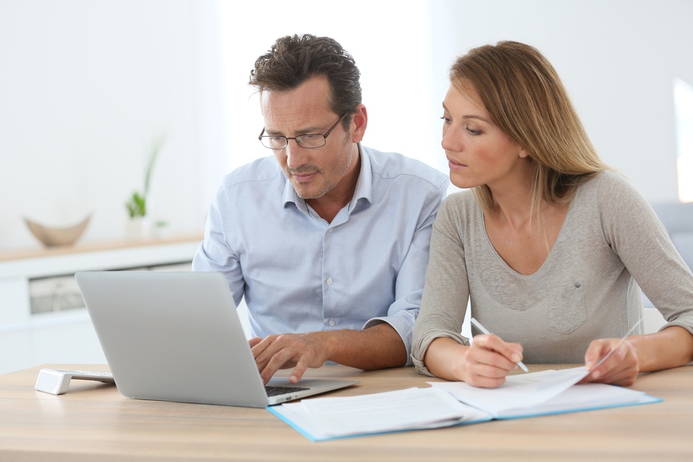 cd rates at america's credit union help your savings grow couple researching rates on laptop